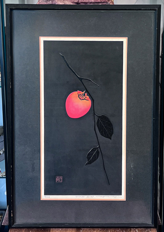 Textured woodblock print of a persimmon on a black background by Haku Maki